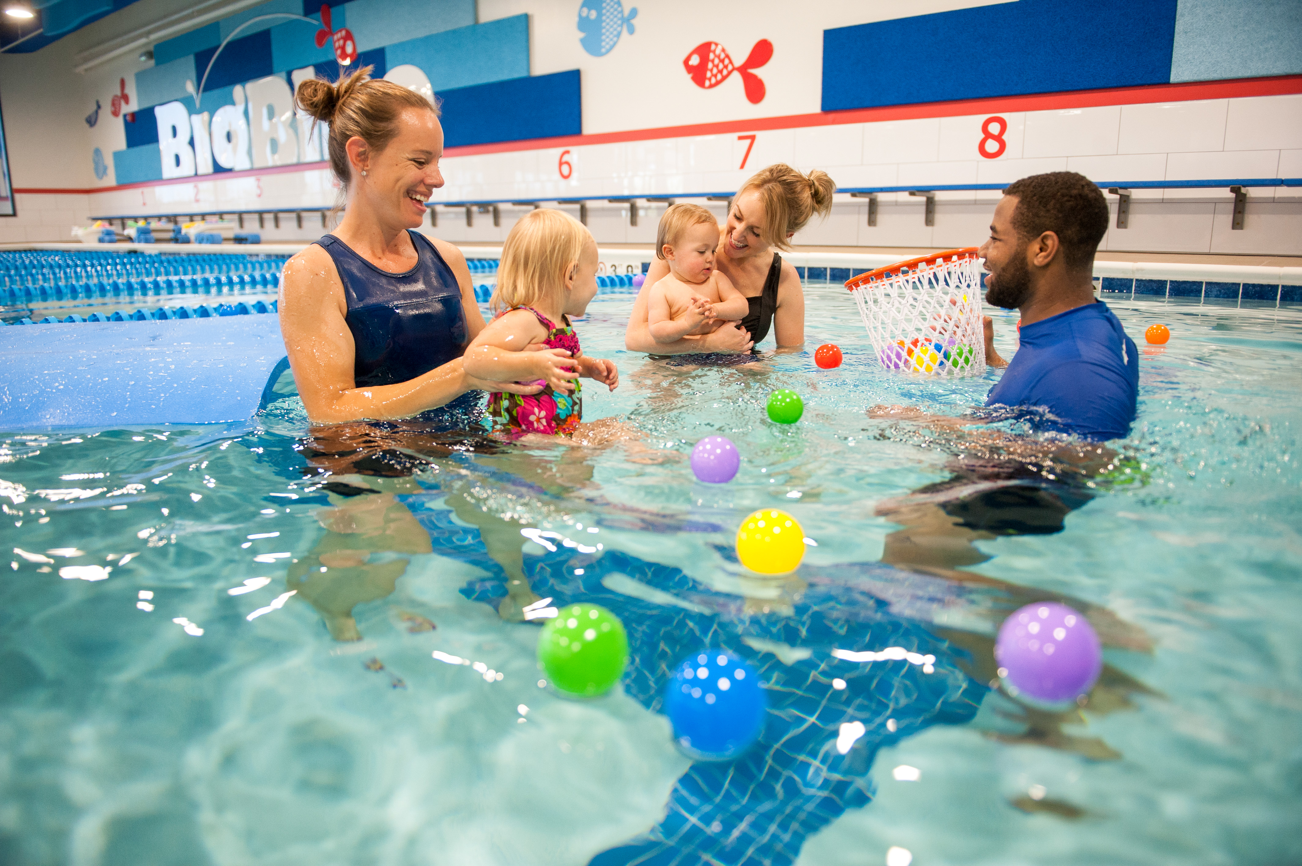 Babies swimming in a Baby Blue swim lesson with their parents