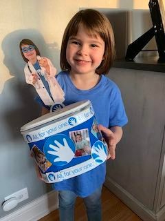 Gracie Miehlke shows off her Lurie fundraising box from Big Blue Wilmette