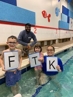 Grace and big brother Lucas take a picture during swim lessons with Nicole and Sal of Big Blue Wilmette
