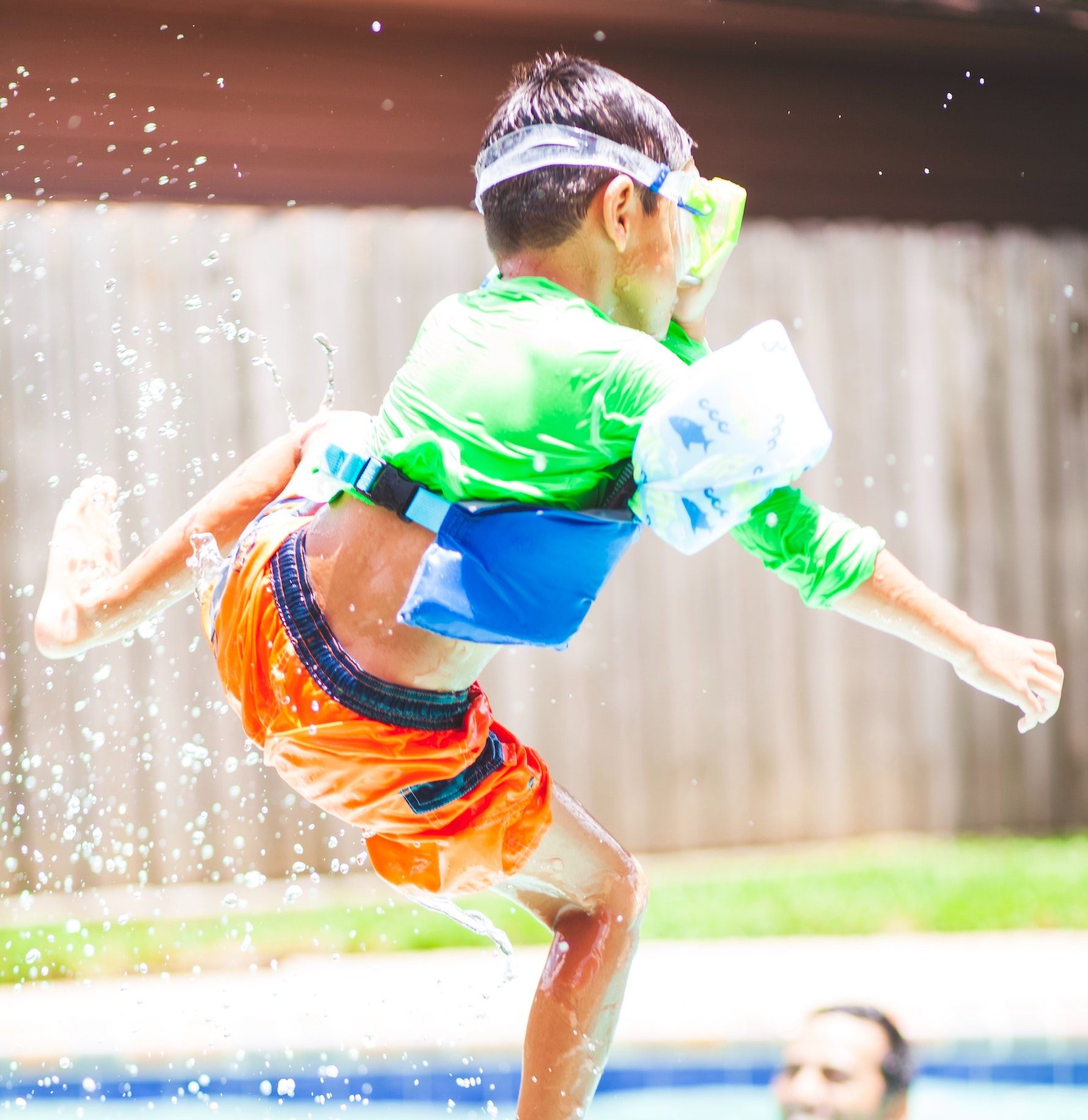 Boy wearing arm floaties