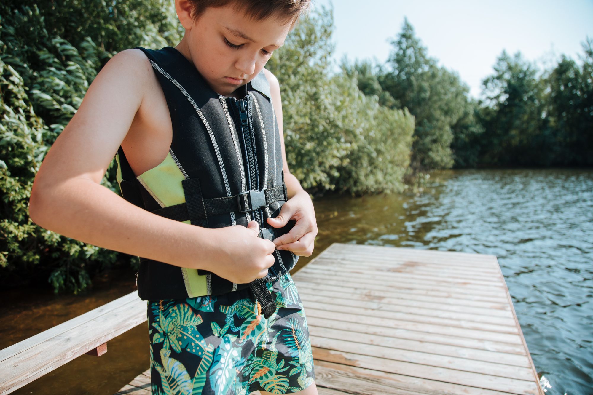 Boy securing his life jacket