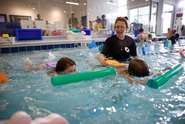 Kids with faces under water building confidence during swim lessons