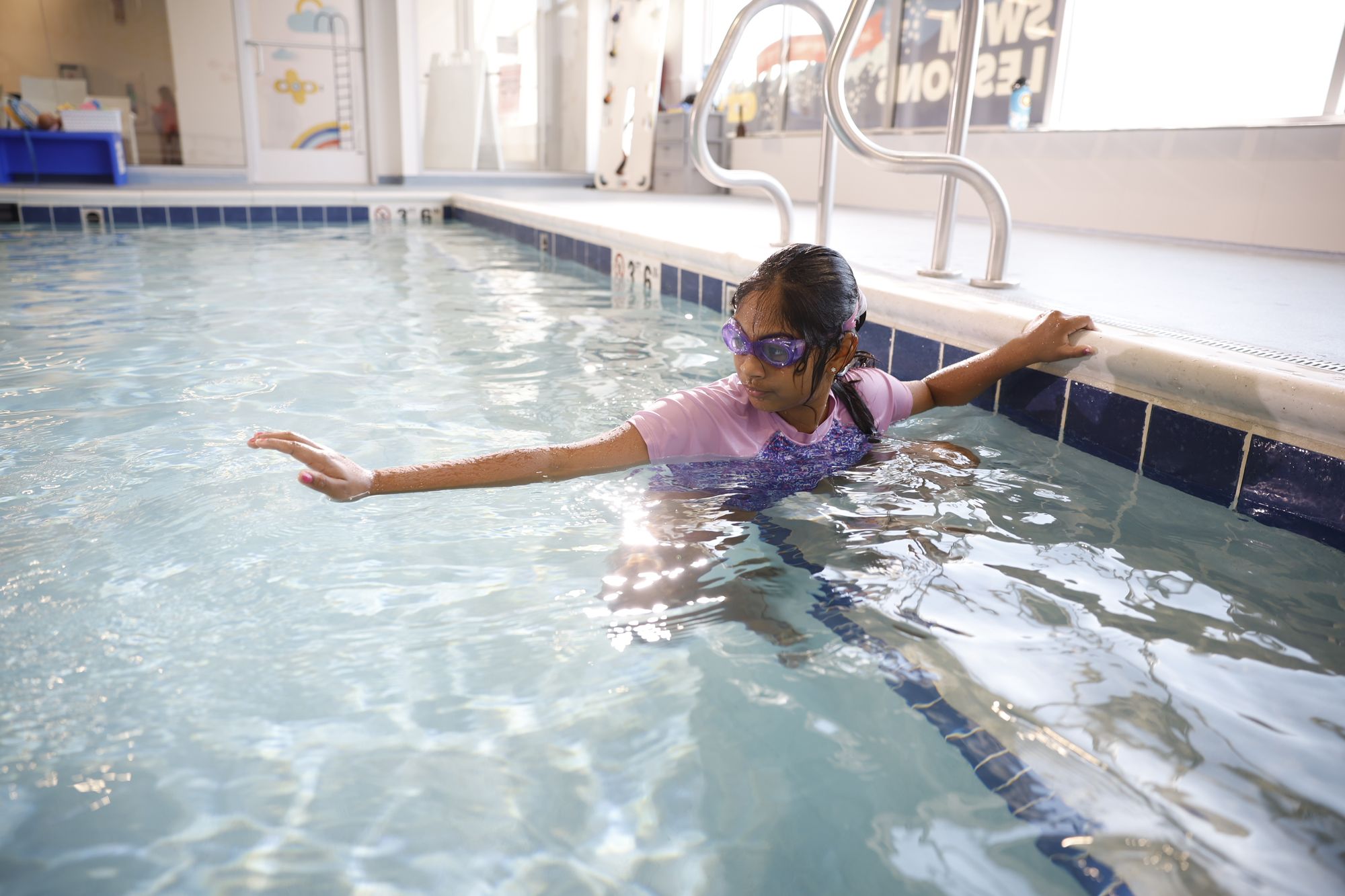 Young swimmer prepares to begin swimming the length of the pool