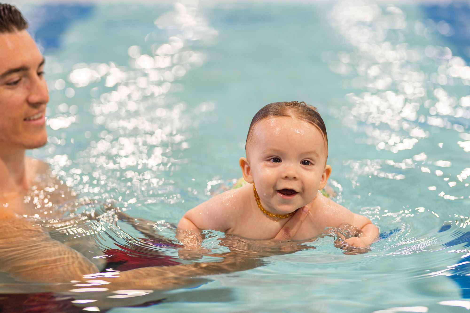Little baby taking swim lessons