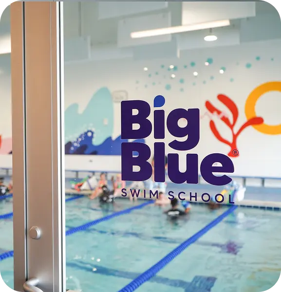 Big Blue Swim School decal on the clear door into the pool